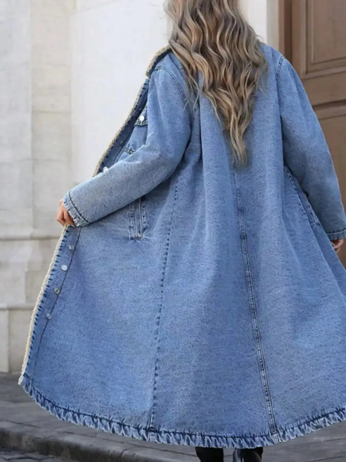 Women’s longline denim jacket with plush sherpa lining, cozy fall and winter outerwear by Plush Fashion Hub.