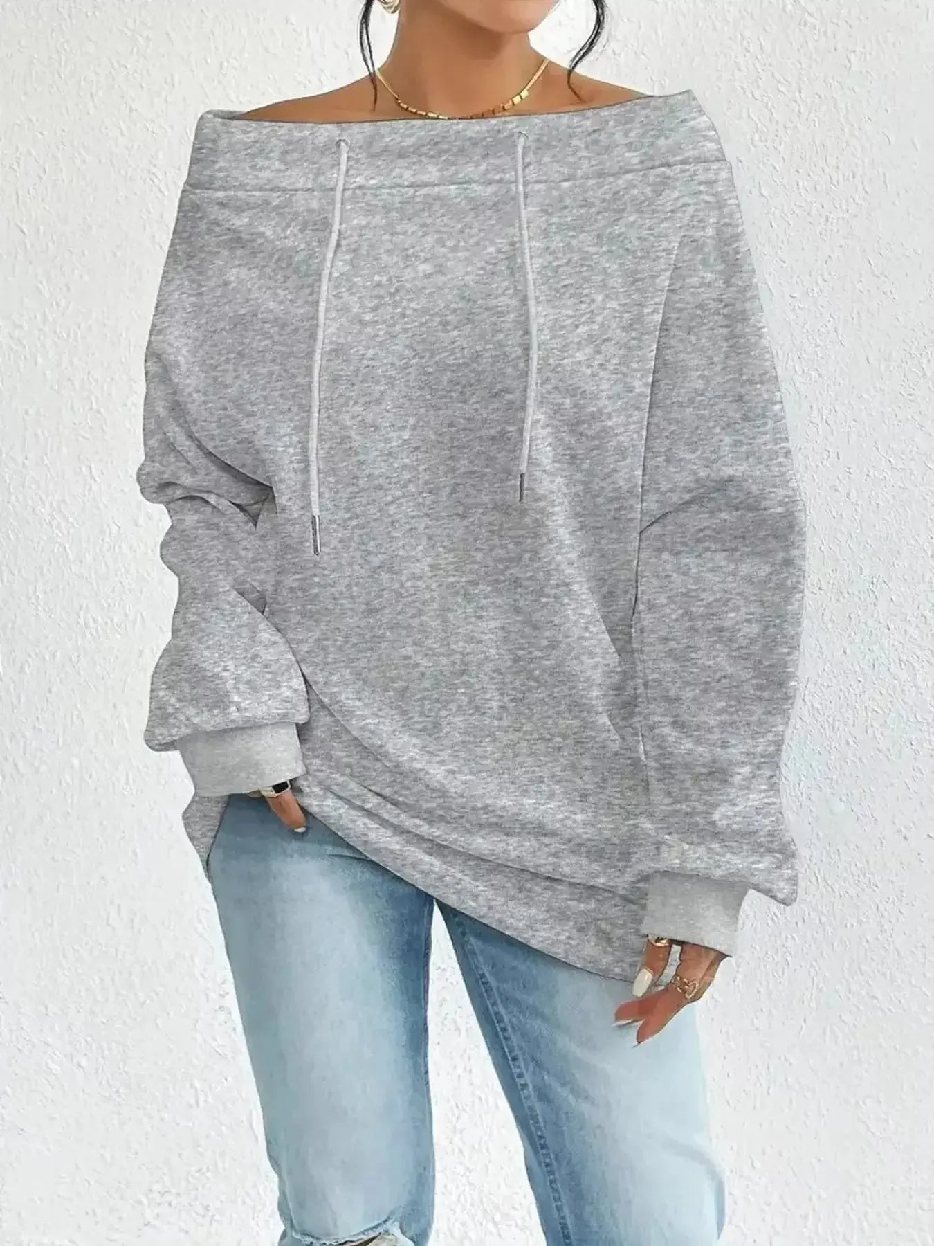 Women’s off-shoulder long sleeve drawstring sweatshirt by Trendsi, featuring plush fabric and a relaxed fit for casual comfort.