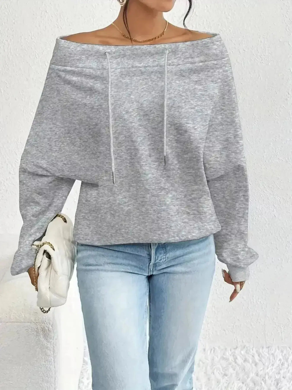 Women's off-shoulder long sleeve drawstring sweatshirt by Trendsi, plush fashion hub, showing a cozy, stylish sweatshirt with relaxed fit.