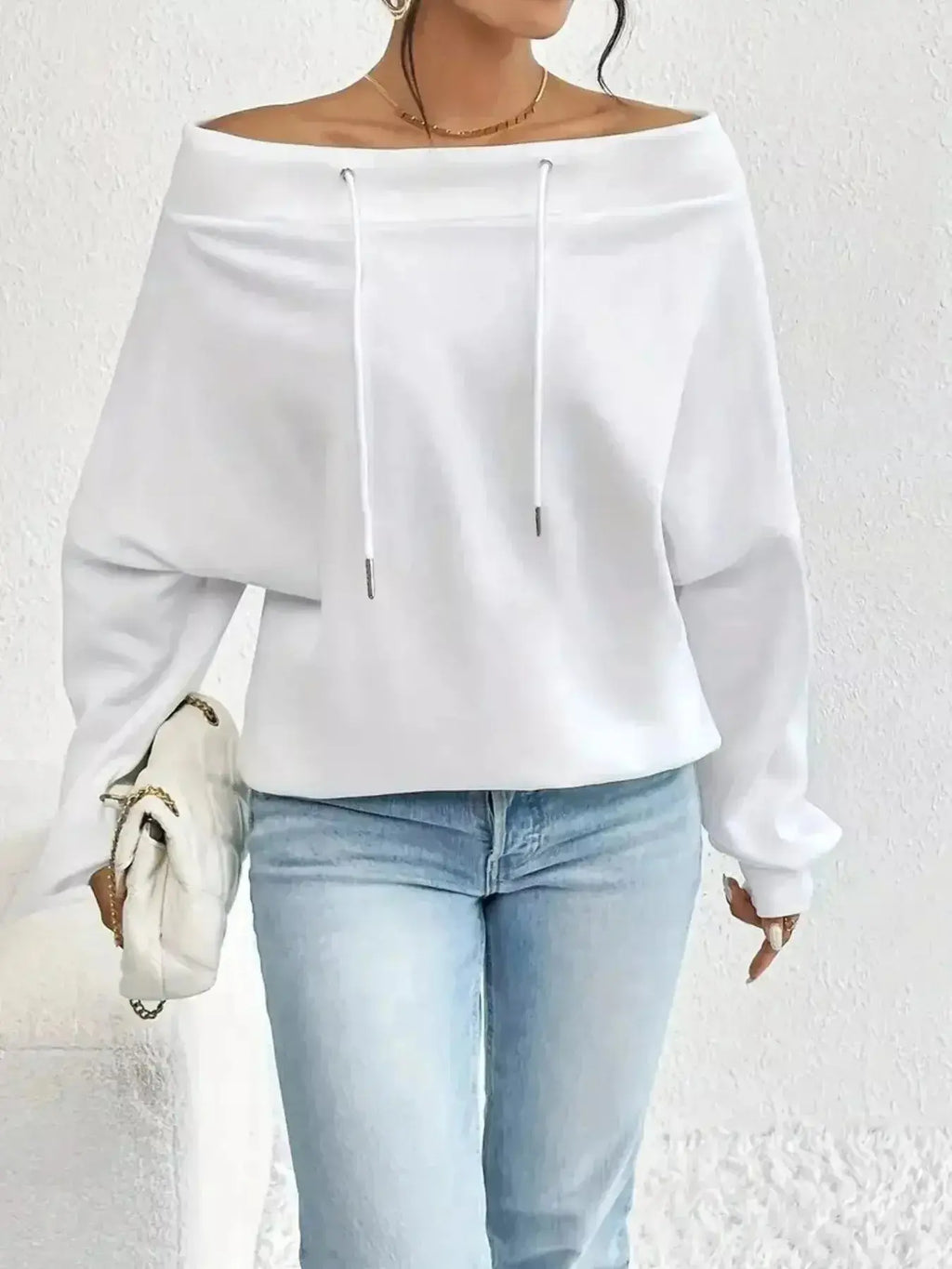 Women's off-shoulder long sleeve drawstring sweatshirt from Trendsi, featuring plush fabric and relaxed fit.