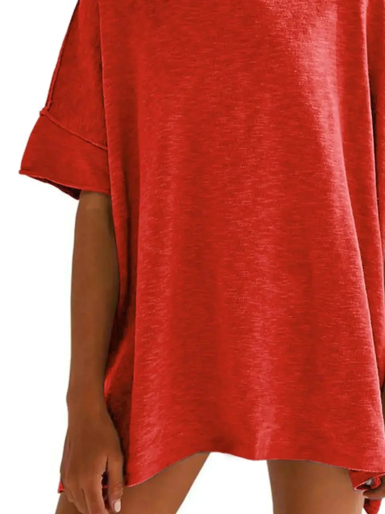 Women’s oversized drop-shoulder round neck T-shirt by Trendsi, relaxed casual fit, soft fabric, worn by a model in a light-colored top.