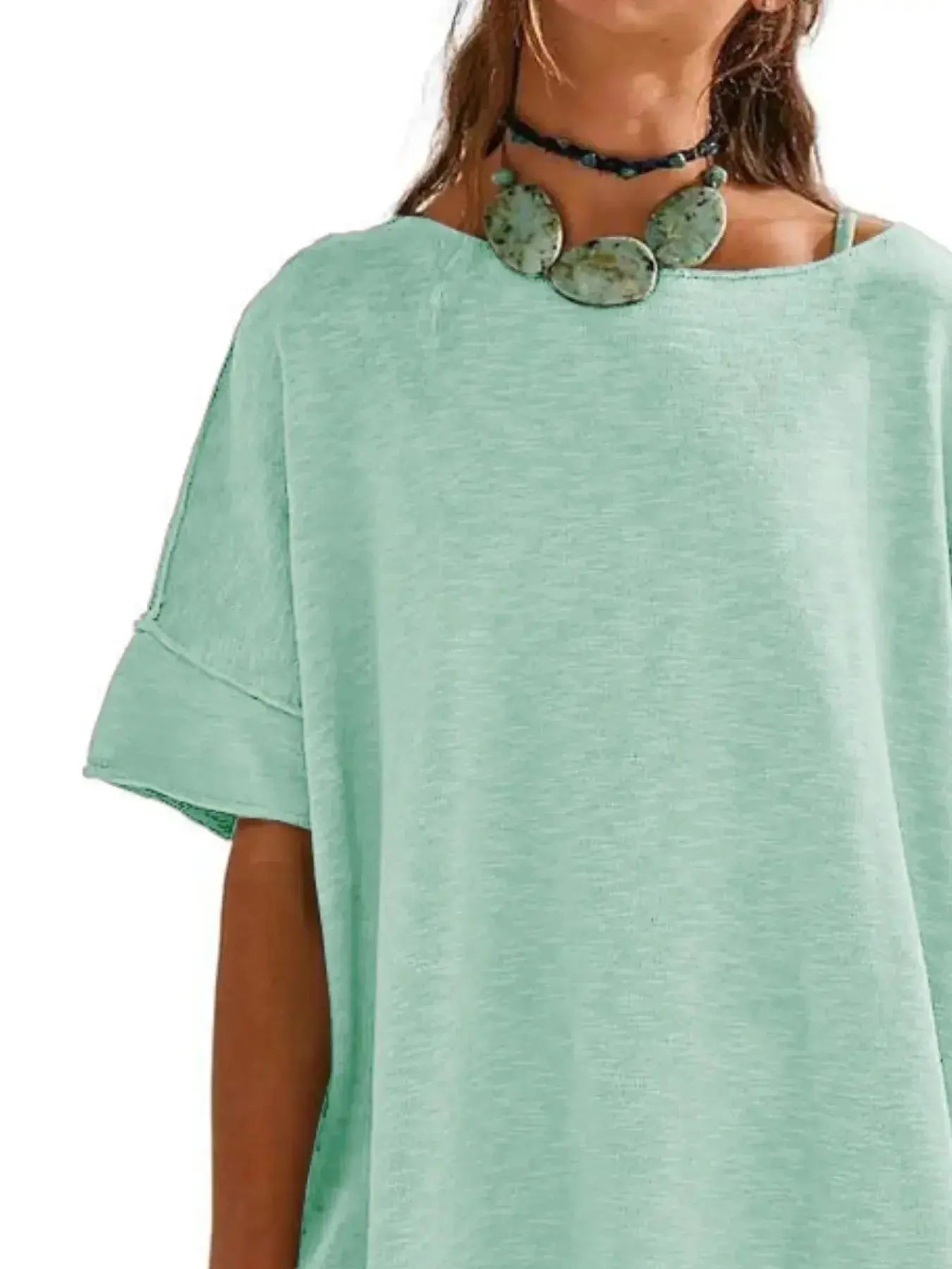 Women’s oversized drop-shoulder round neck T-shirt by Trendsi, relaxed casual fit, soft fabric, and stylish relaxed silhouette.