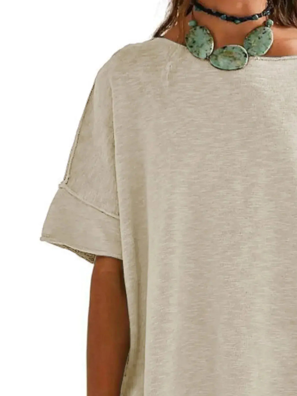 Women’s oversized drop-shoulder round neck T-shirt by Trendsi, relaxed casual style, soft fabric, and loose fit.