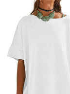 Women’s oversized drop-shoulder round neck T-shirt by Trendsi, relaxed casual fit, soft fabric, displayed on a model.