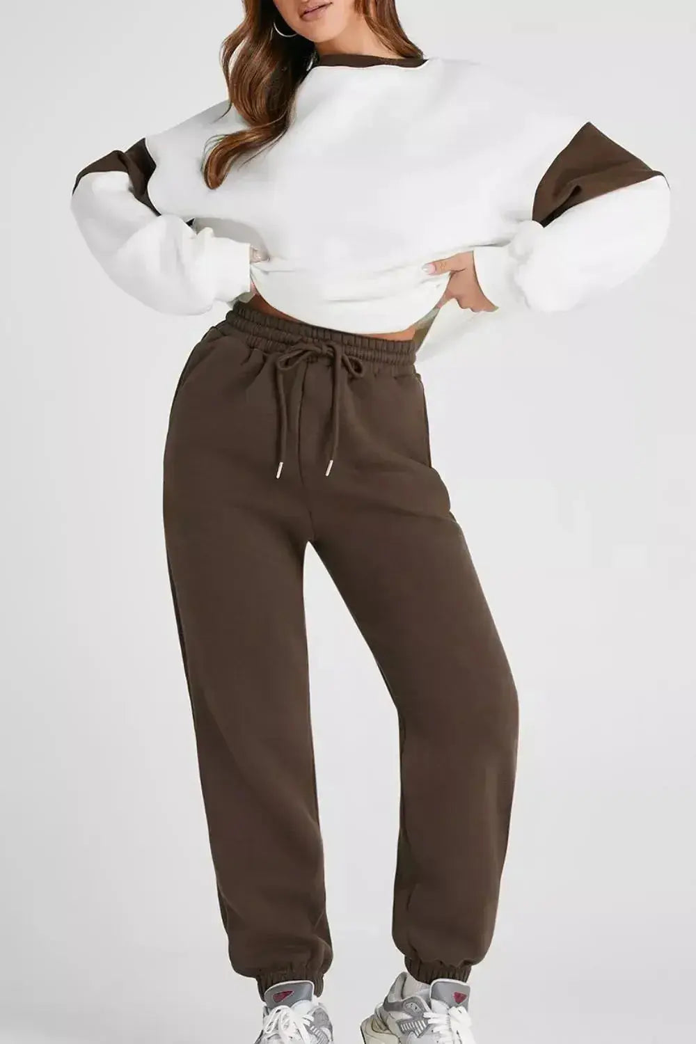 Women wearing Plush Fashion Hub oversized drop shoulder sweatshirt and matching joggers loungewear set for casual comfort.