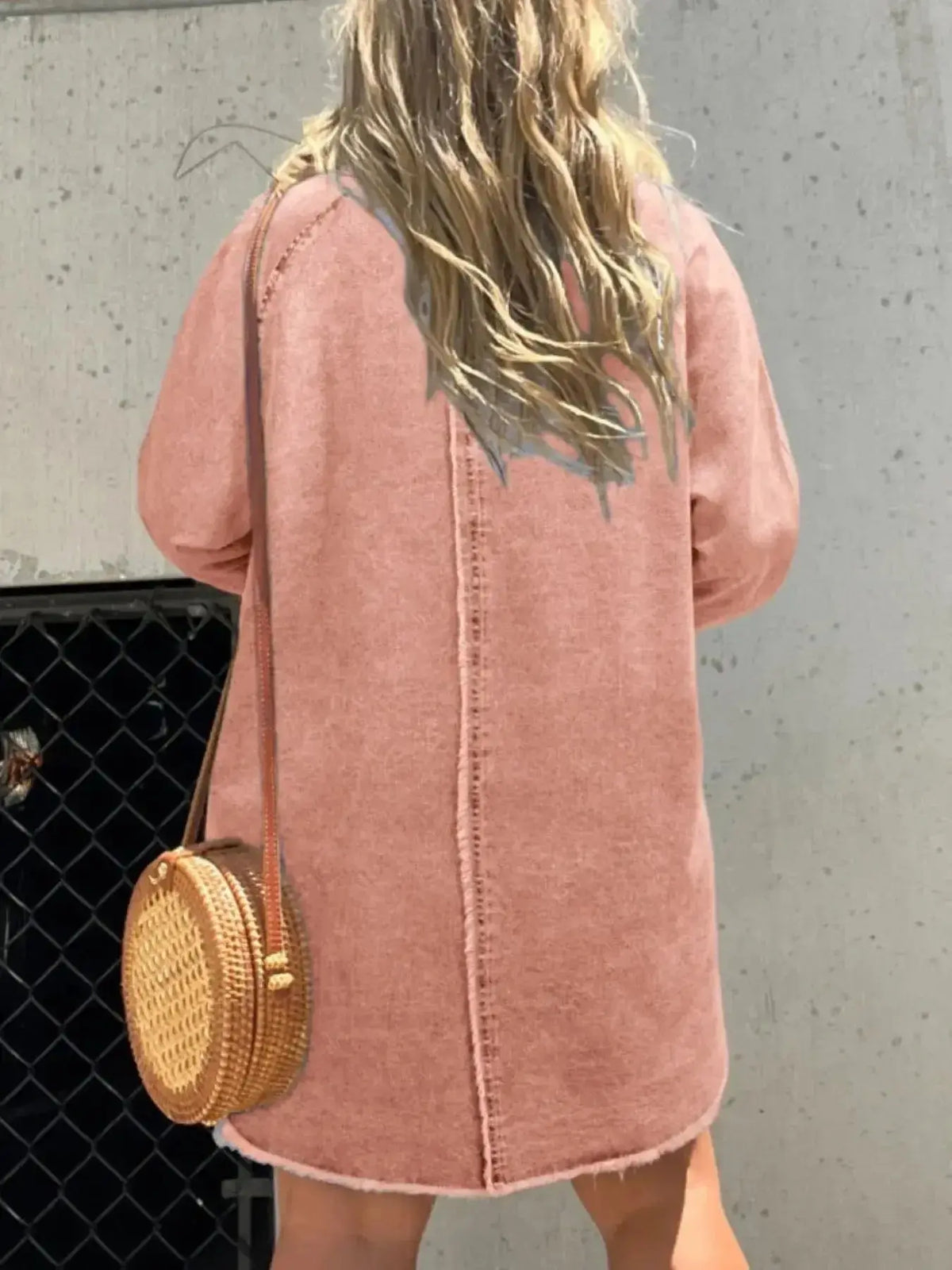 Women’s oversized denim shirt dress with long sleeves and front pockets, from Plush Fashion Hub, styled casually.