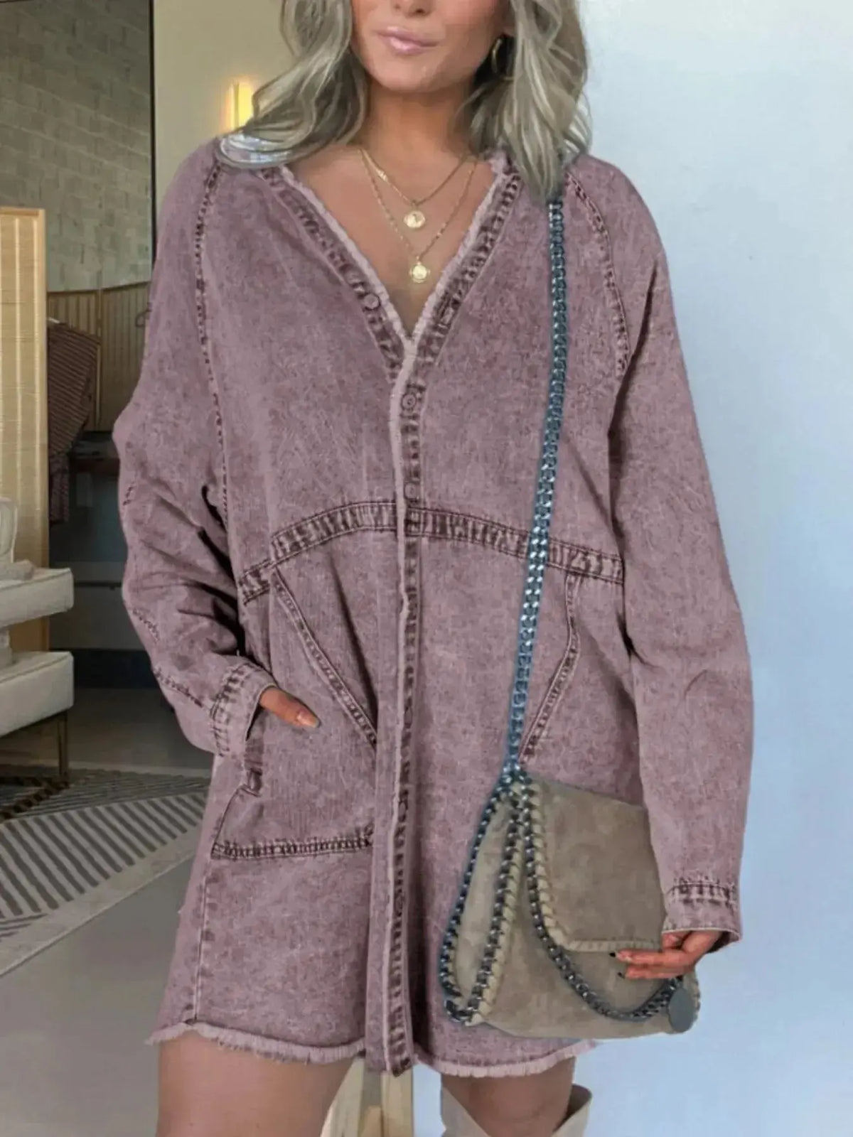 Women’s oversized denim shirt dress with long sleeves and front pockets, styled by Plush Fashion Hub.