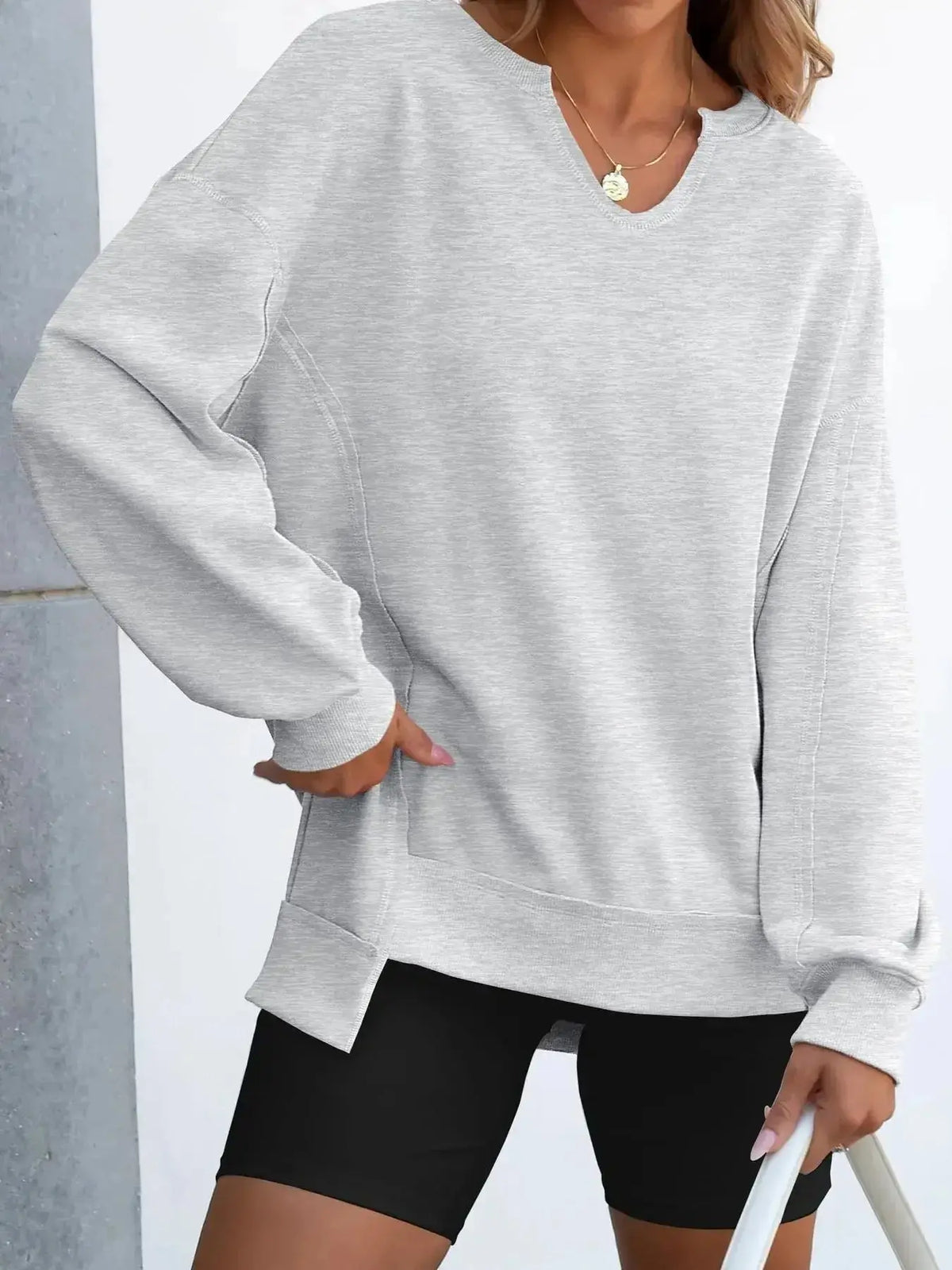 Women’s oversized sweatshirt with notched neckline and contrast stitching from Plush Fashion Hub, featuring a relaxed fit and stylish details.