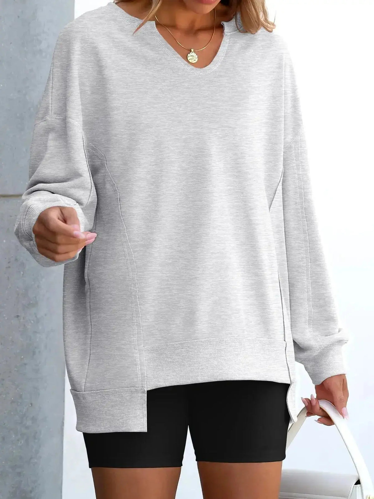 Women’s oversized notched neck sweatshirt by Plush Fashion Hub with contrast stitching, featuring a relaxed fit and stylish design.