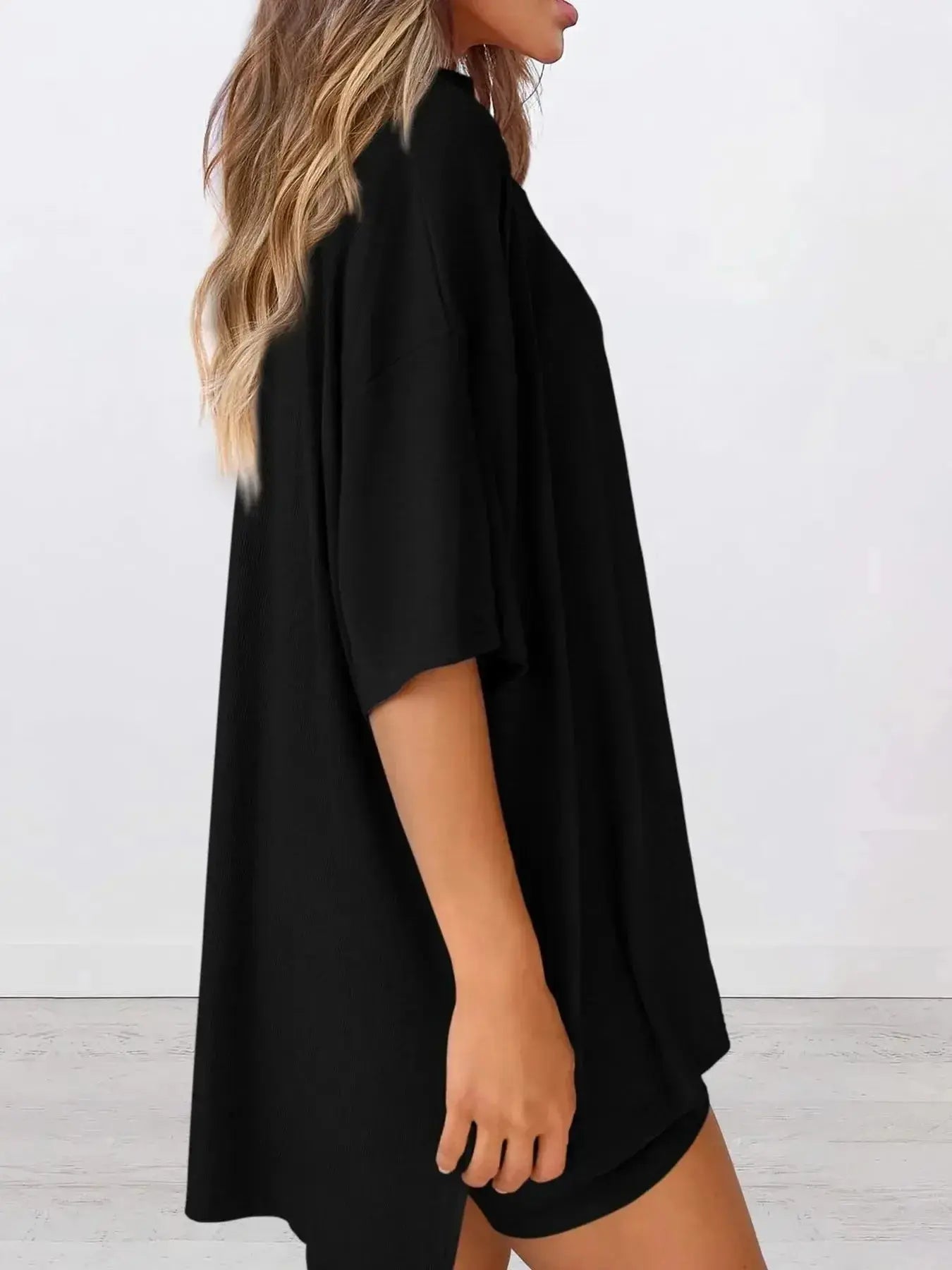 Women’s oversized round neck loungewear set by Trendsi, featuring a comfortable two-piece lounge shirt and pants.