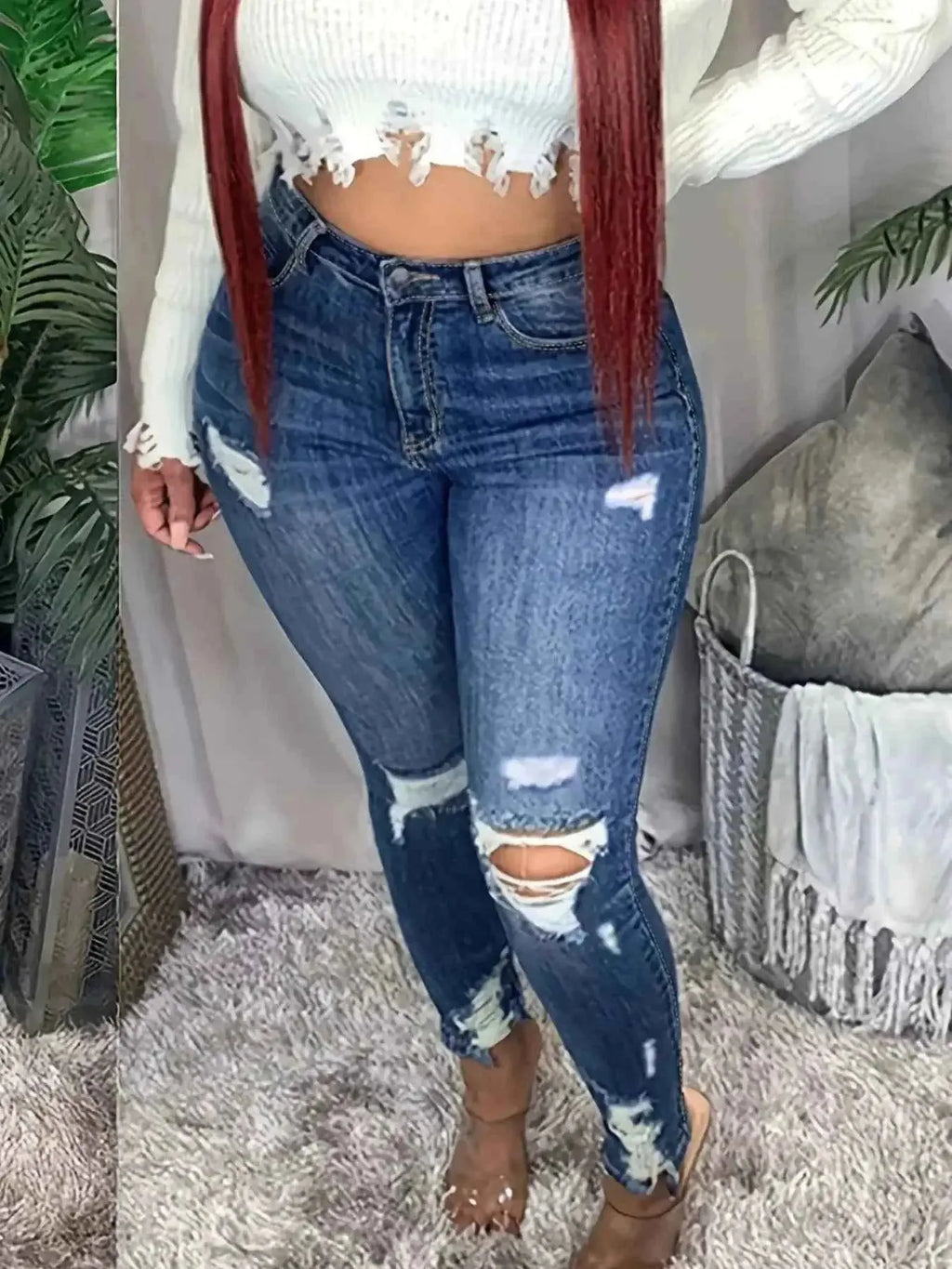 Plus size women's distressed slim fit jeans with raw hem from Trendsi, showcasing a stylish fit and raw edge detail.