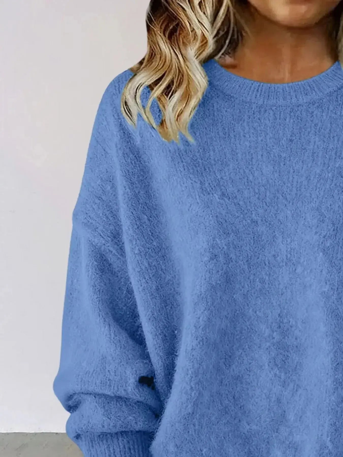 Plus size women's relaxed fit sweater with dropped shoulders and round neck, by Trendsi, shown in a cozy knit style.