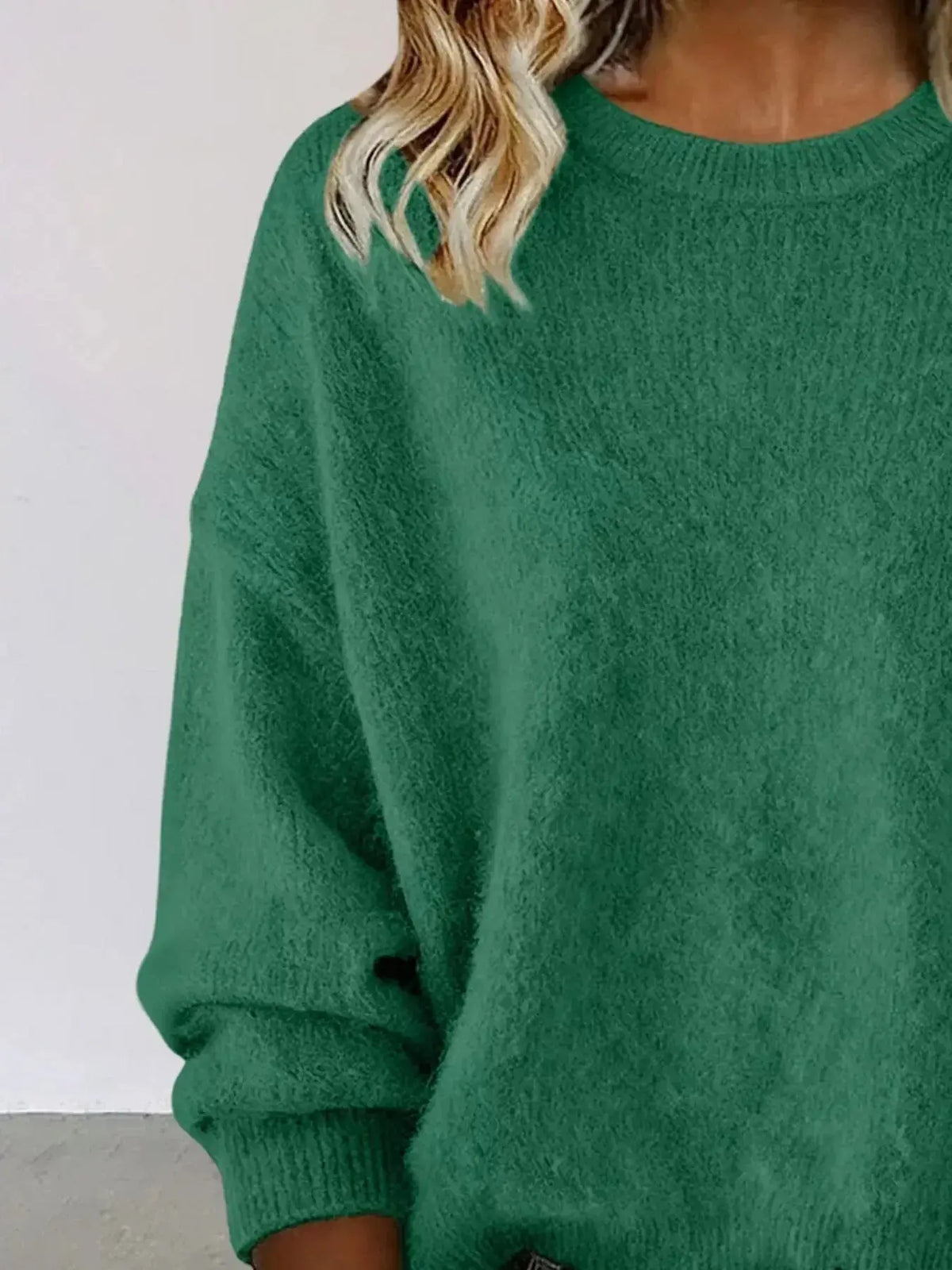 Plus size women's relaxed fit sweater with dropped shoulders and round neckline, in soft knit fabric from Plush Fashion Hub.