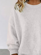 Plus size women's relaxed fit sweater with dropped shoulders and round neck, from Trendsi, stylish and comfortable knit sweater.