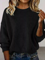 Plus size women's relaxed fit sweater with dropped shoulders and round neckline, from Trendsi. Soft, cozy knit for casual wear.