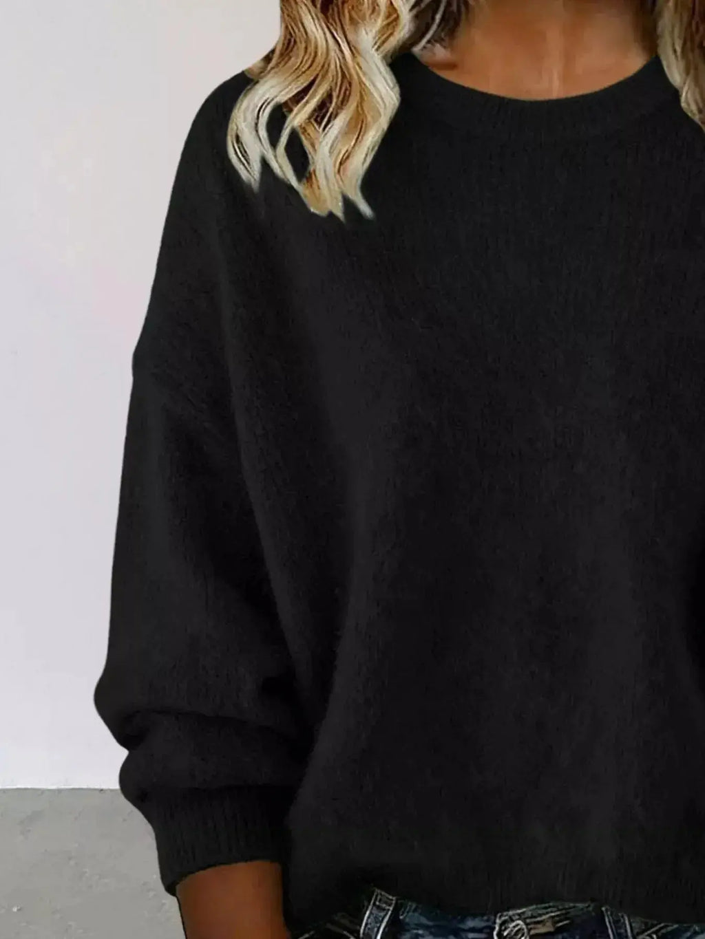 Plus size women's relaxed fit sweater with dropped shoulders and round neck, by Trendsi, displayed on a model.