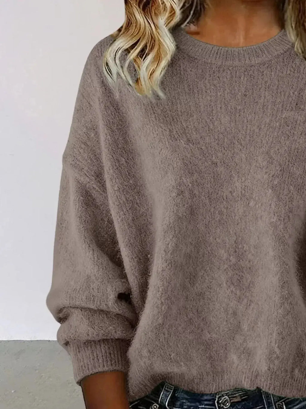 Plus size women's relaxed fit sweater with dropped shoulders and round neck, casual and cozy from Trendsi.