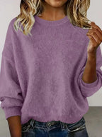 Plus size women's relaxed fit sweater with dropped shoulders and round neck, by Trendsi, shown in a cozy knit style.