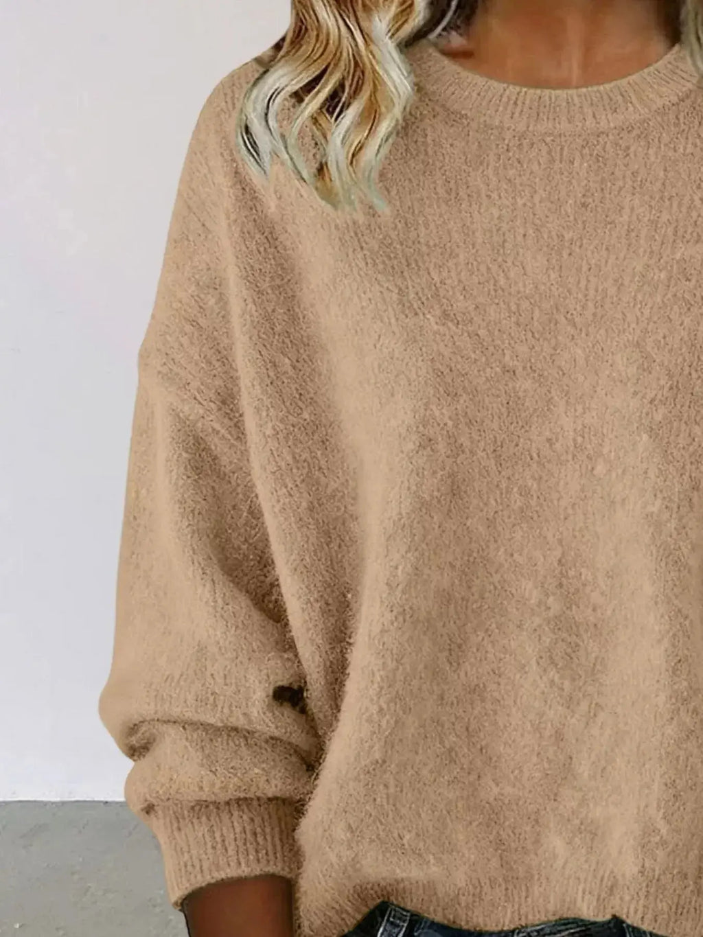 Plus size women's relaxed fit sweater with dropped shoulders and round neck, stylish Trendsi sweater for casual wear.