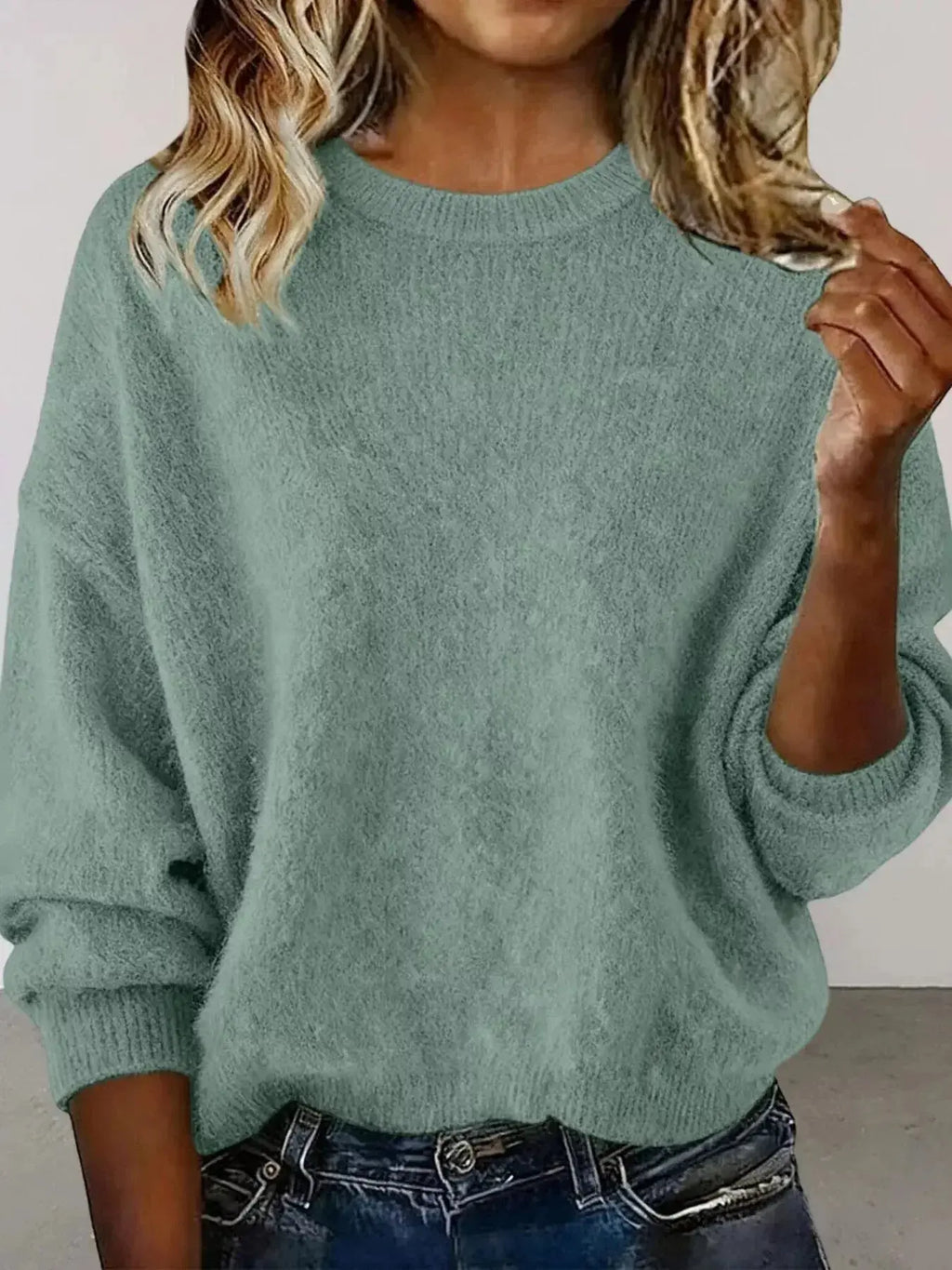 Plus size women's relaxed fit sweater with dropped shoulders and round neckline, stylish and comfortable from Trendsi.