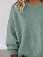 Plus size women's relaxed fit dropped shoulder round neck sweater by Trendsi, showcasing soft knit fabric and cozy style.