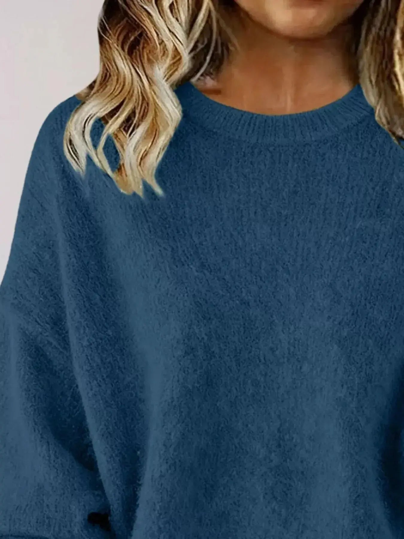 Plus size women's relaxed fit dropped shoulder round neck sweater by Trendsi, showcased in a casual, comfortable fit.
