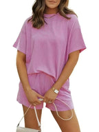 Plus size women's ribbed short sleeve pajama top and shorts lounge set by Trendsi, featuring comfortable, casual sleepwear.