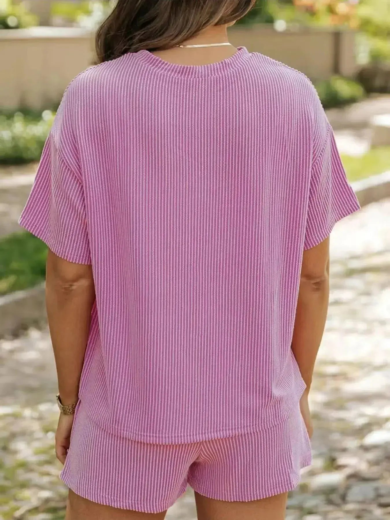 Plus size women's ribbed pajama top and shorts lounge set by Trendsi, featuring short sleeves and comfortable fabric.