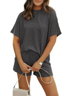 Plus size ribbed pajama set for women featuring short sleeve top and matching shorts by Trendsi, perfect for comfortable loungewear.