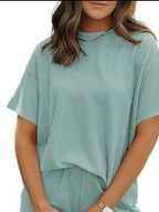 Plus size women's ribbed short sleeve pajama top and shorts lounge set by Trendsi, comfortable sleepwear for relaxed nights.