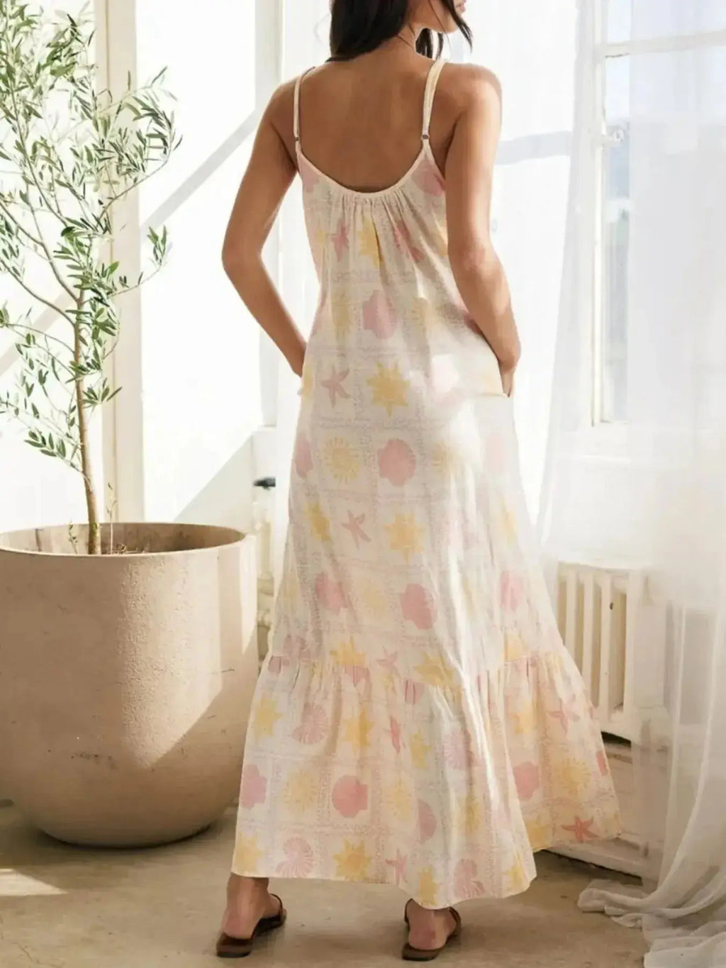 Women's printed maxi lounge dress by Trendsi featuring ruffled hem, pockets, and a comfortable pajama style.