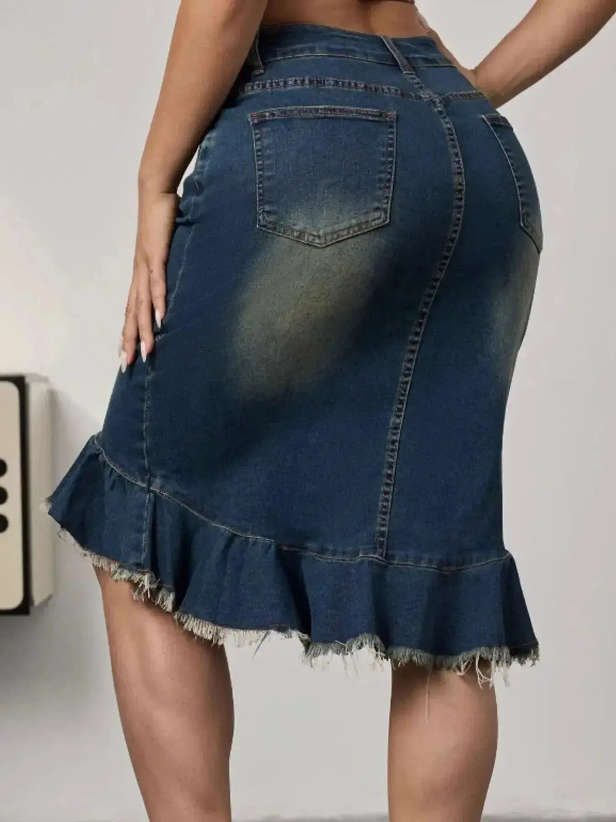 Women’s stretchy blue denim midi skirt with raw hem and mermaid silhouette from Plush Fashion Hub, showcasing a stylish denim look.