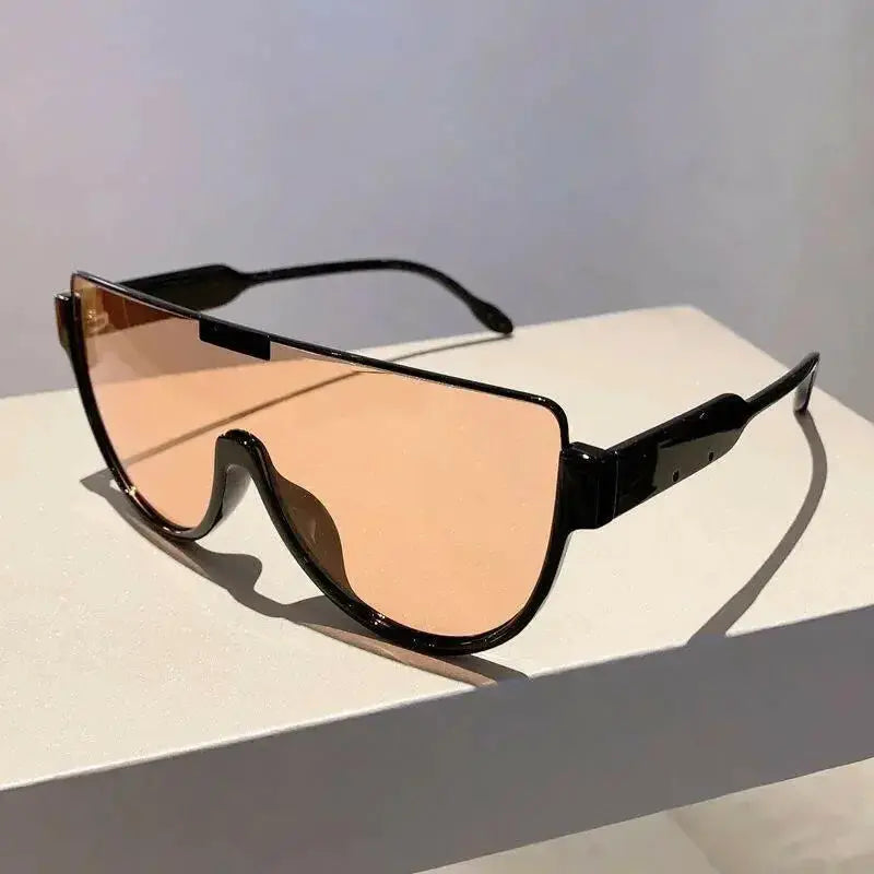 Women wearing oversized retro one-piece sunglasses by Plush Fashion Hub, lightweight shield style with stylish design.
