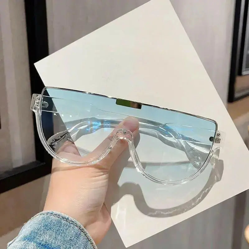 Women wearing plush fashion hub retro oversized shield sunglasses, lightweight one-piece design, stylish and protective eyewear
