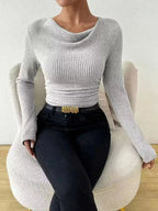 Women's ribbed cowl neck long sleeve sweater with ruched detail from Trendsi, featuring a cozy, fitted design and stylish neckline.