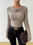 Women’s ribbed cowl neck long sleeve sweater with ruched detail by Trendsi, featuring a cozy, fitted design with ribbed texture.