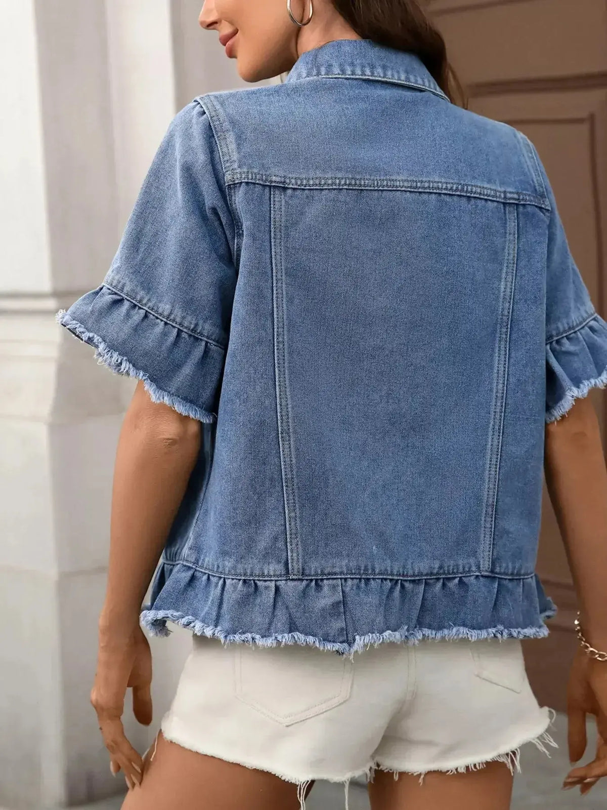 Women’s ruffled raw hem button-up denim jacket by Plush Fashion Hub featuring a stylish raw hem and ruffled details.