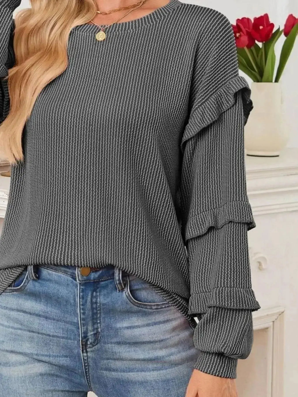 Women’s ribbed long sleeve sweatshirt with ruffled round neck by Trendsi, featuring a cozy, stylish design and ribbed fabric.