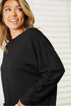 Women’s long sleeve round neck shirt with seam details, comfortable everyday top by Trendsi, suitable for casual wear.