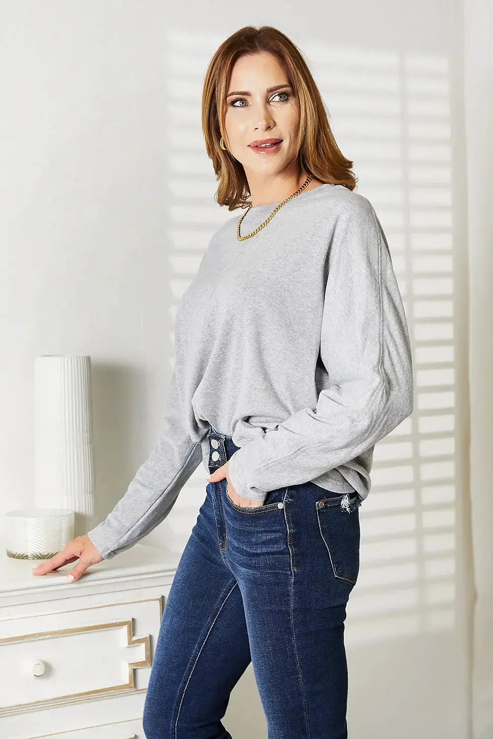 Women's long sleeve round neck shirt with seam detail, comfortable everyday top by Trendsi.