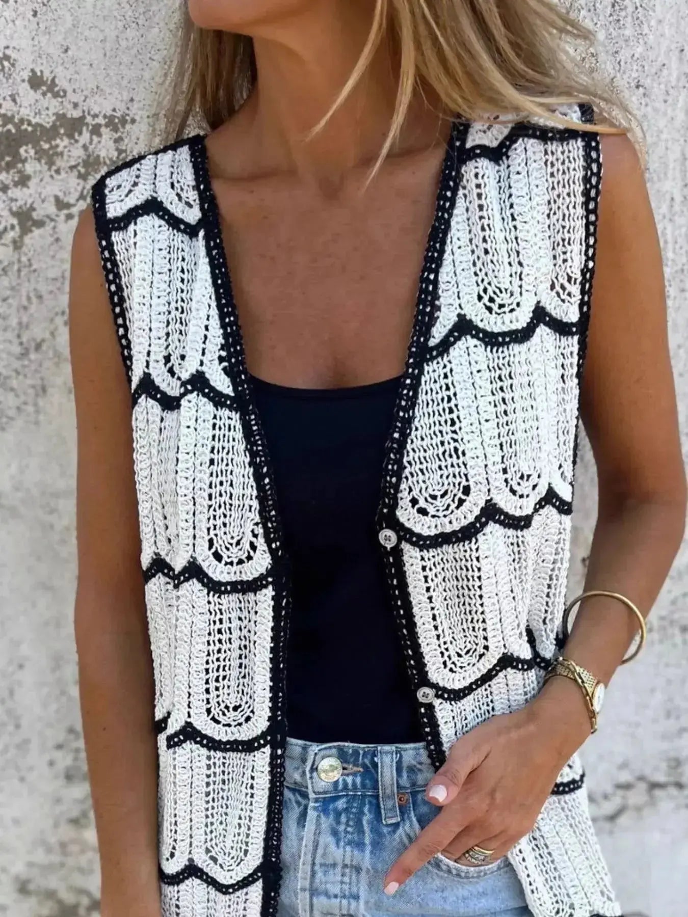 Women's sleeveless crochet longline cardigan with openwork knit pattern and button-front vest, stylish sweater by Trendsi.