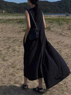 Women wearing a sleeveless, irregular hem solid color maxi dress from Plush Fashion Hub, showcasing a flowing, elegant long dress.