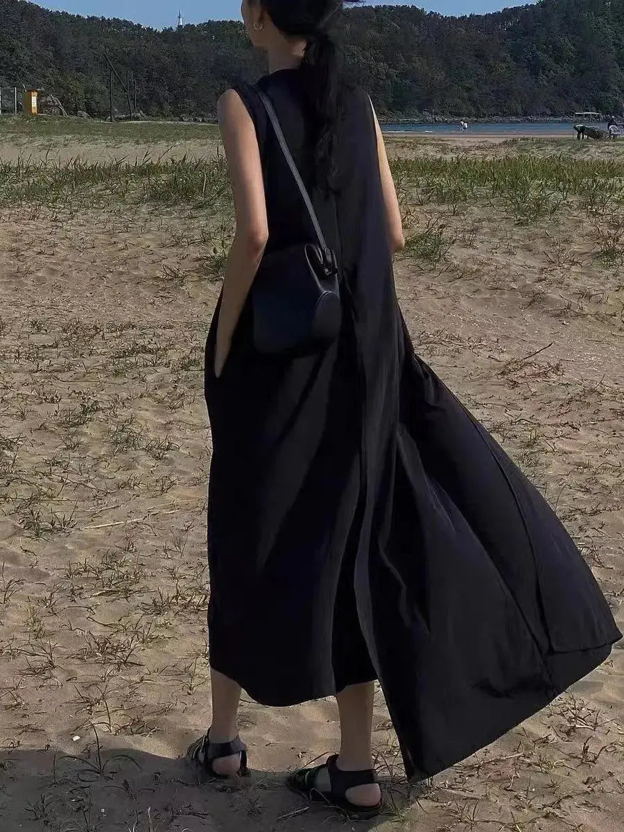 Women wearing a sleeveless, irregular hem solid color maxi dress from Plush Fashion Hub, showcasing a flowing, elegant long dress.