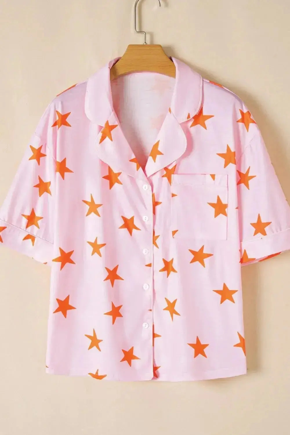Women’s star print short sleeve button-down pajama set by Trendsi, featuring a comfortable, stylish pajama top and matching shorts.