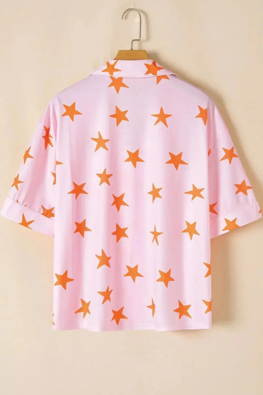Women's star print short sleeve button-down pajama set by Trendsi, featuring a comfortable, relaxed fit and stylish star pattern.