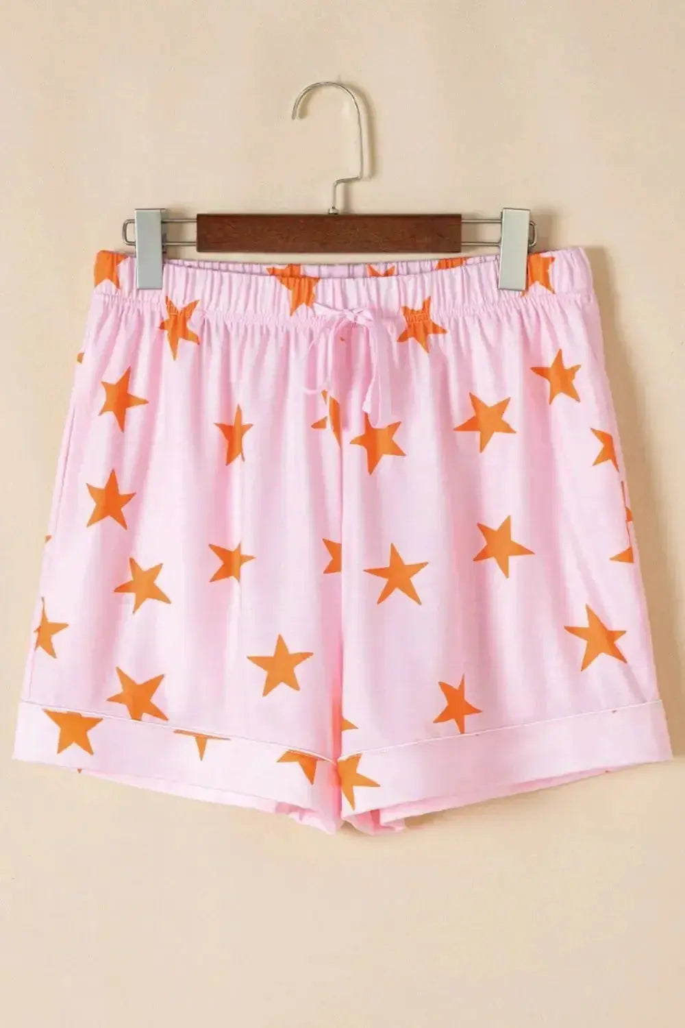 Women's star print short sleeve button-down pajama set by Trendsi, featuring comfortable fabric and relaxed fit for sleepwear.