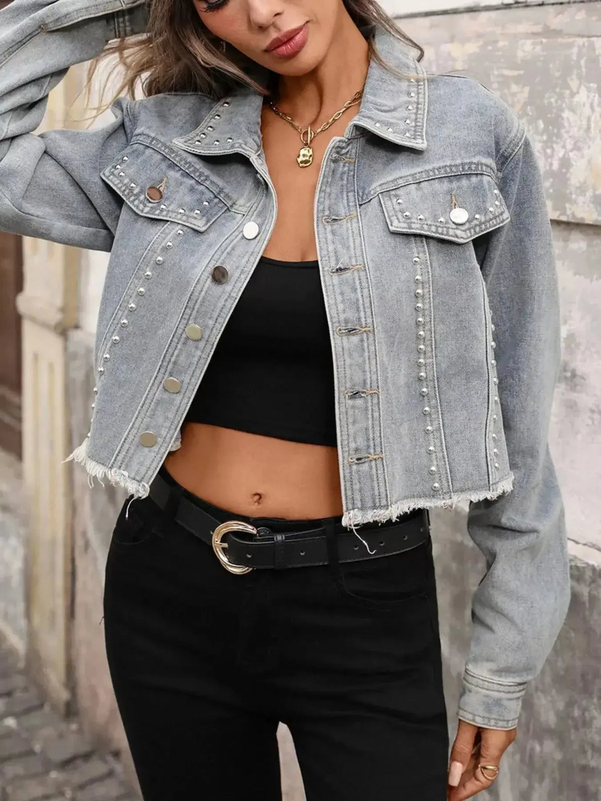 Women’s distressed blue denim jacket with studded detailing and raw hem, stylish women’s denim jacket from Plush Fashion Hub.