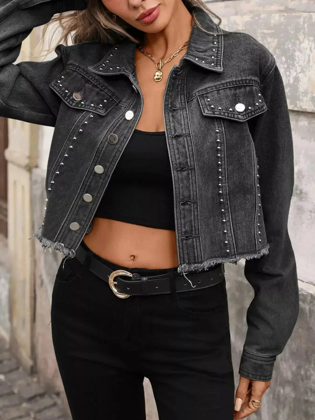 Women’s studded raw hem denim jacket in distressed blue, stylish denim jacket with embellishments and rugged finish by Plush Fashion Hub.