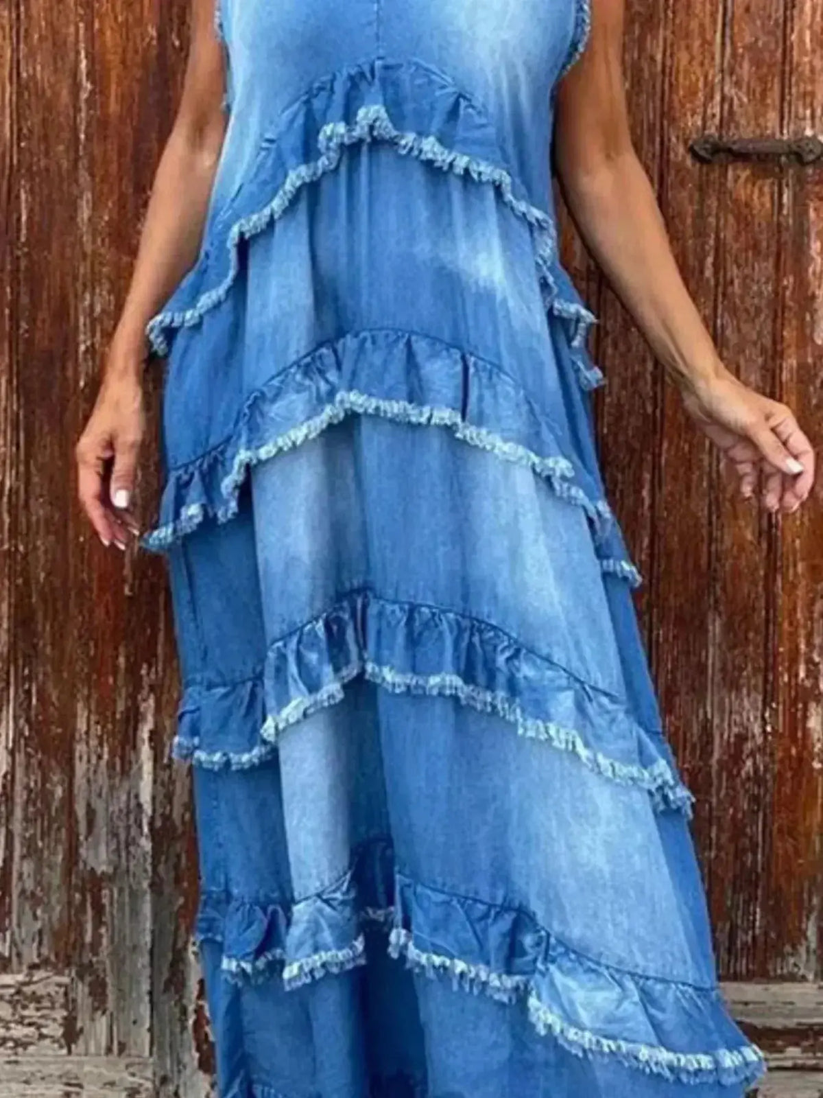 Women wearing a tiered raw hem denim maxi dress with ruffled details, casual style from Plush Fashion Hub.