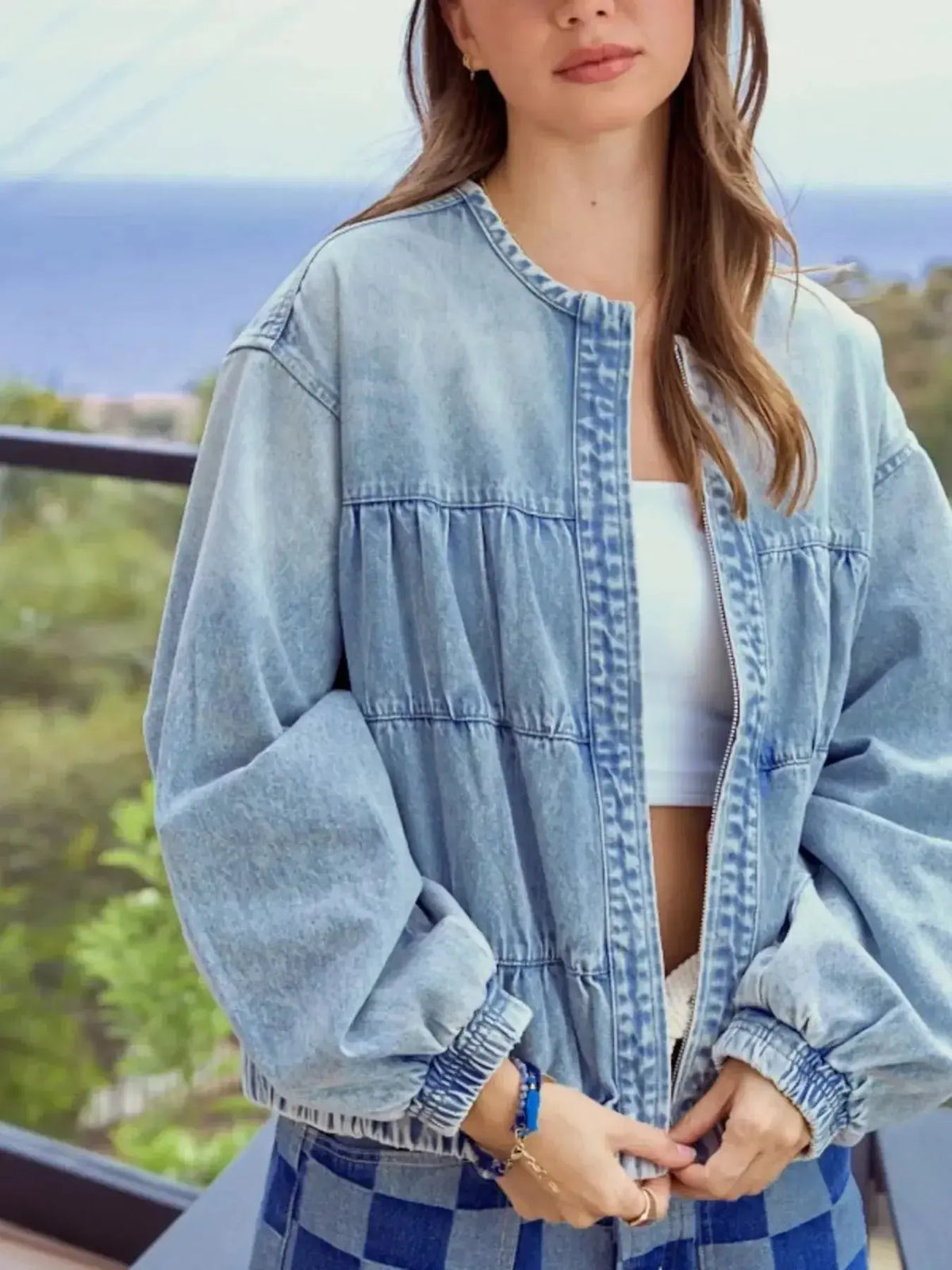 Women’s vintage washed zip-up denim jacket by Plush Fashion Hub, featuring structured cotton blend fabric and classic denim style.